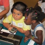 a boy and a girl listening to an audio book