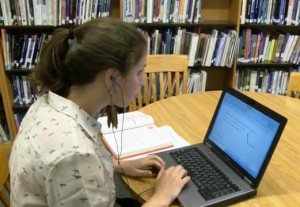 b-roll library girl looking labtop (0;09;57;19)