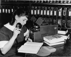 Black and White Photo of Volunteer Recording Book