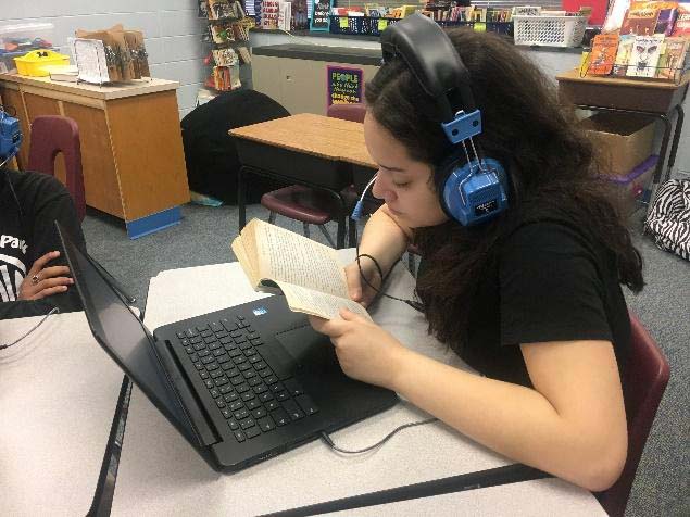Girl Reads Using Assistive Technology