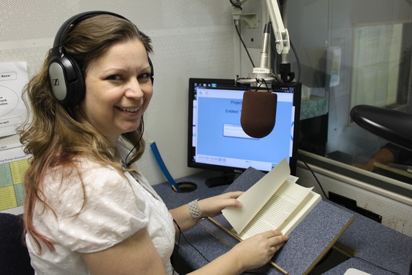 Deanna reading and recording an audiobook